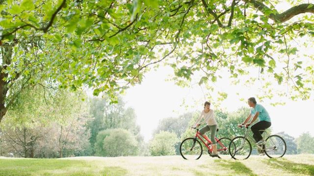 couple cycling in park